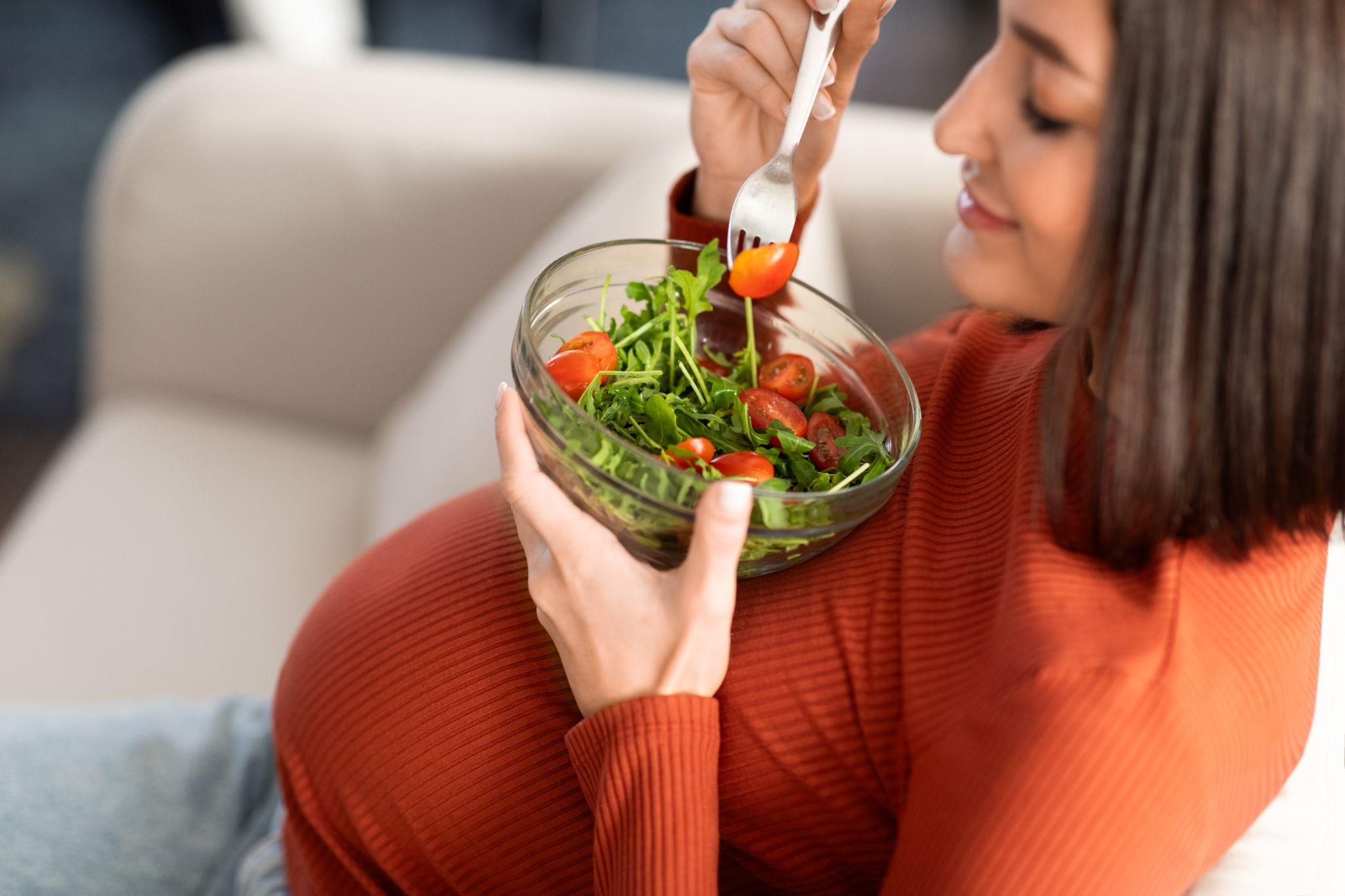 A pregnant woman enjoying a nutritious meal during her antenatal journey.