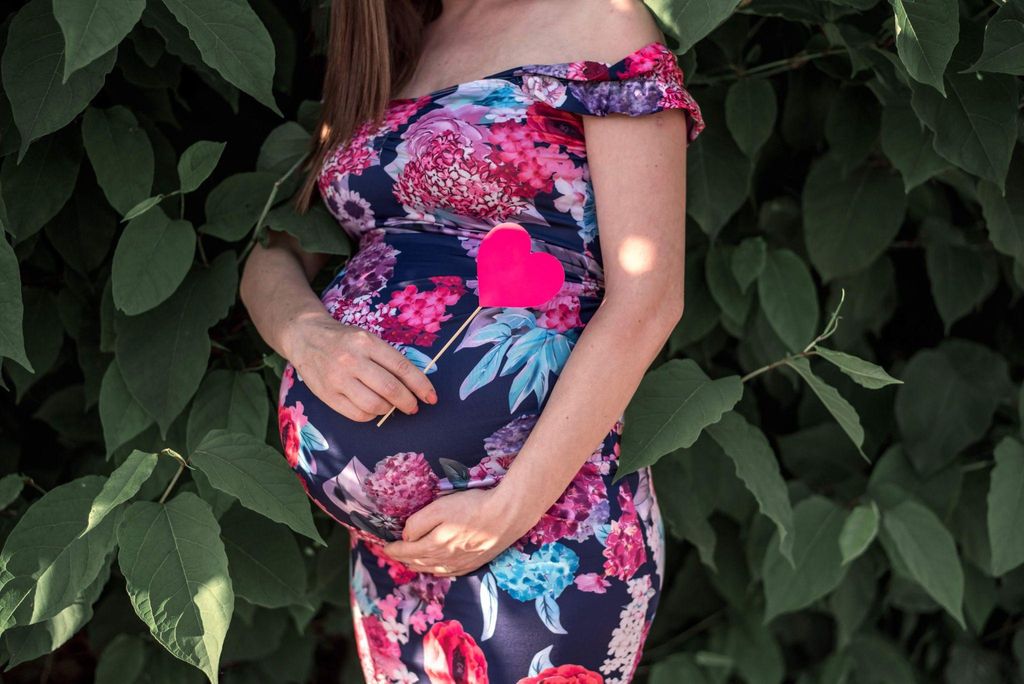 A woman engaging in yoga during pregnancy to promote relaxation and well-being.