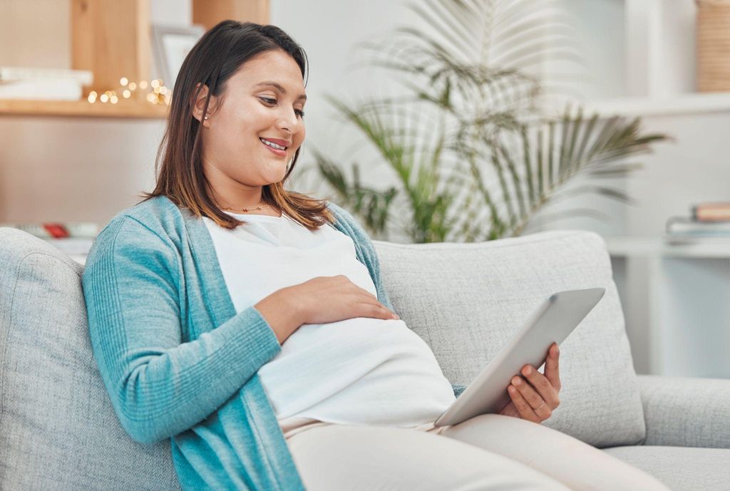 Couple preparing for childbirth, reviewing a birth plan and discussing preferences.