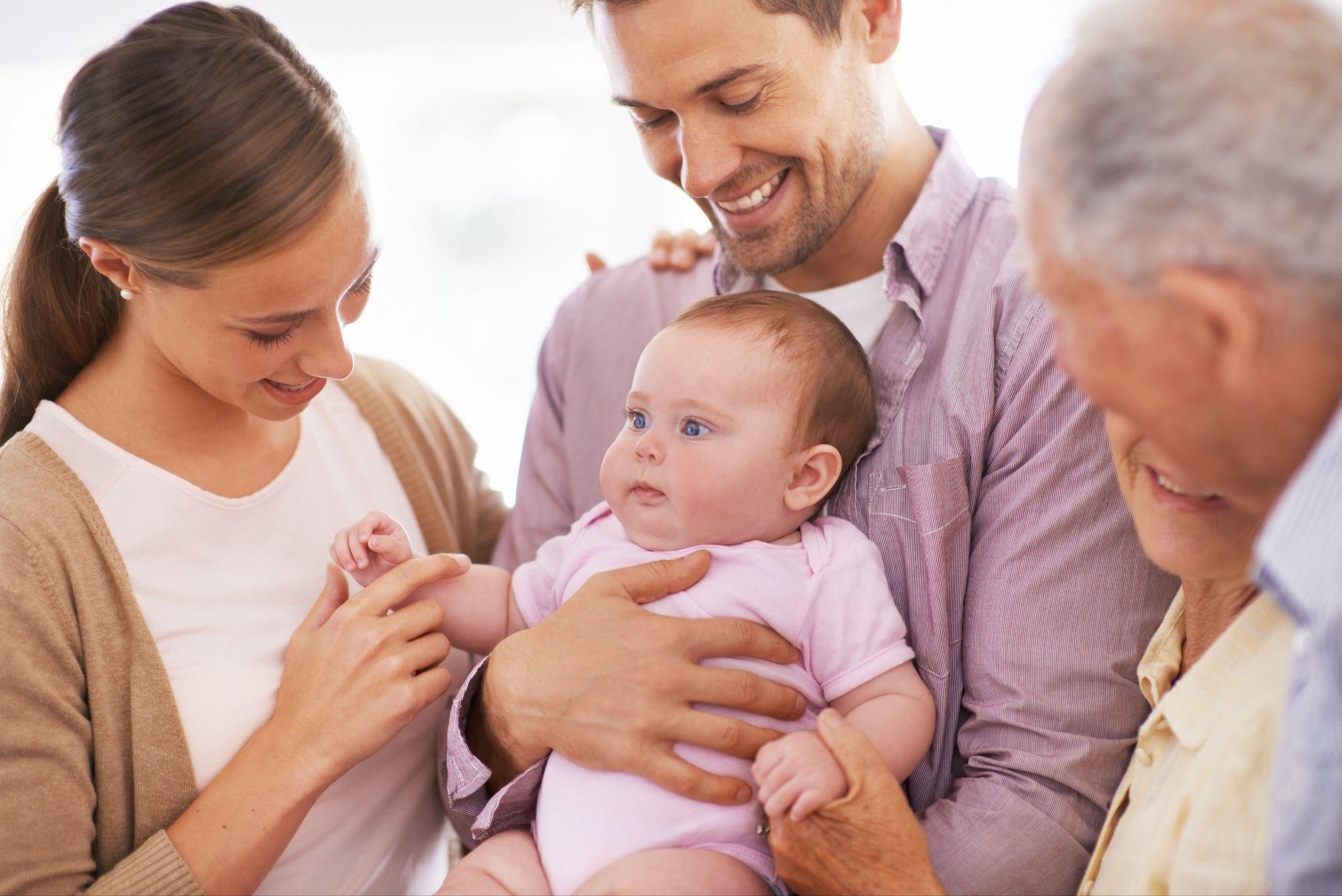 A couple bonding with their newborn in a cosy home environment.