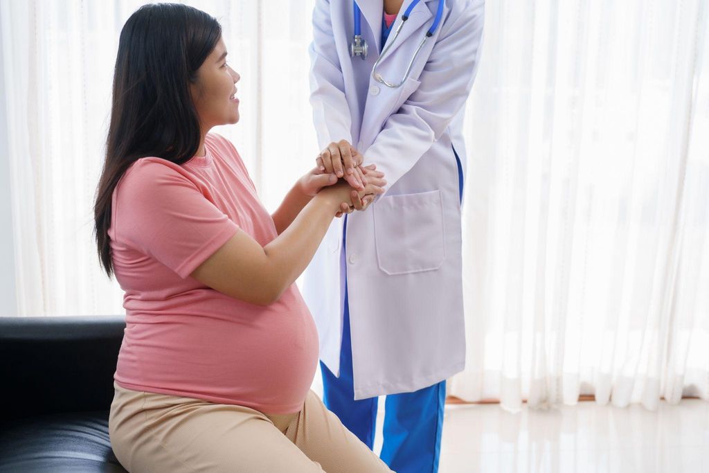 A pregnant woman attending an antenatal consultation with her healthcare provider.