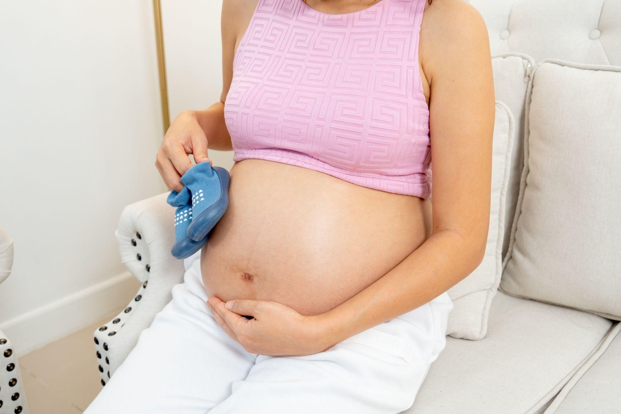 A pregnant woman practising antenatal yoga to relieve second-trimester cramps.