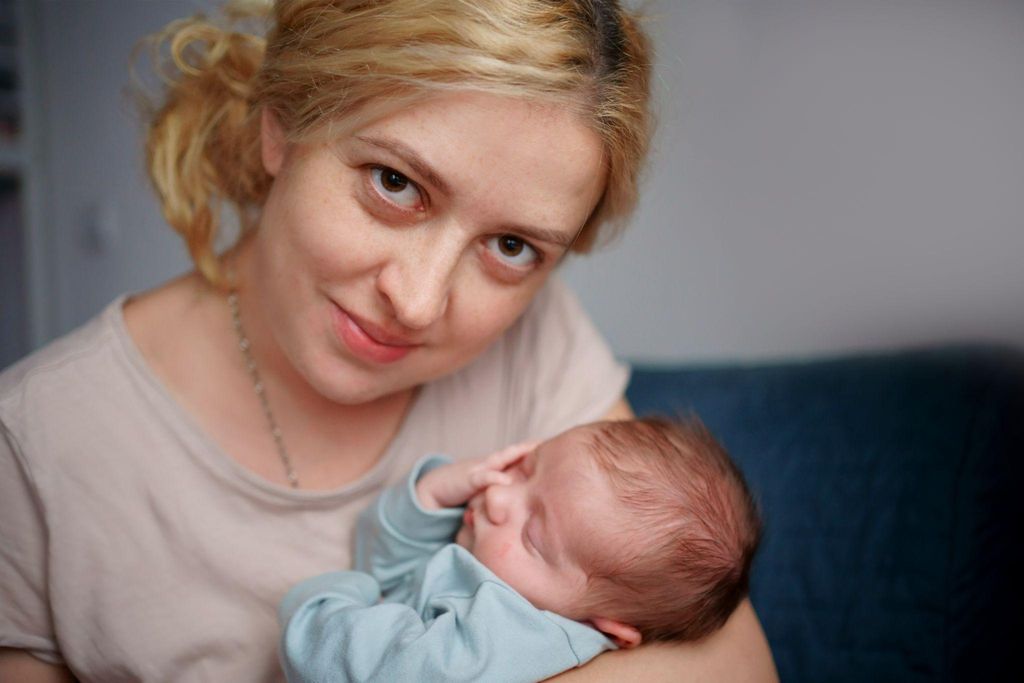 A mother recovering from a C-section while bonding with her newborn.