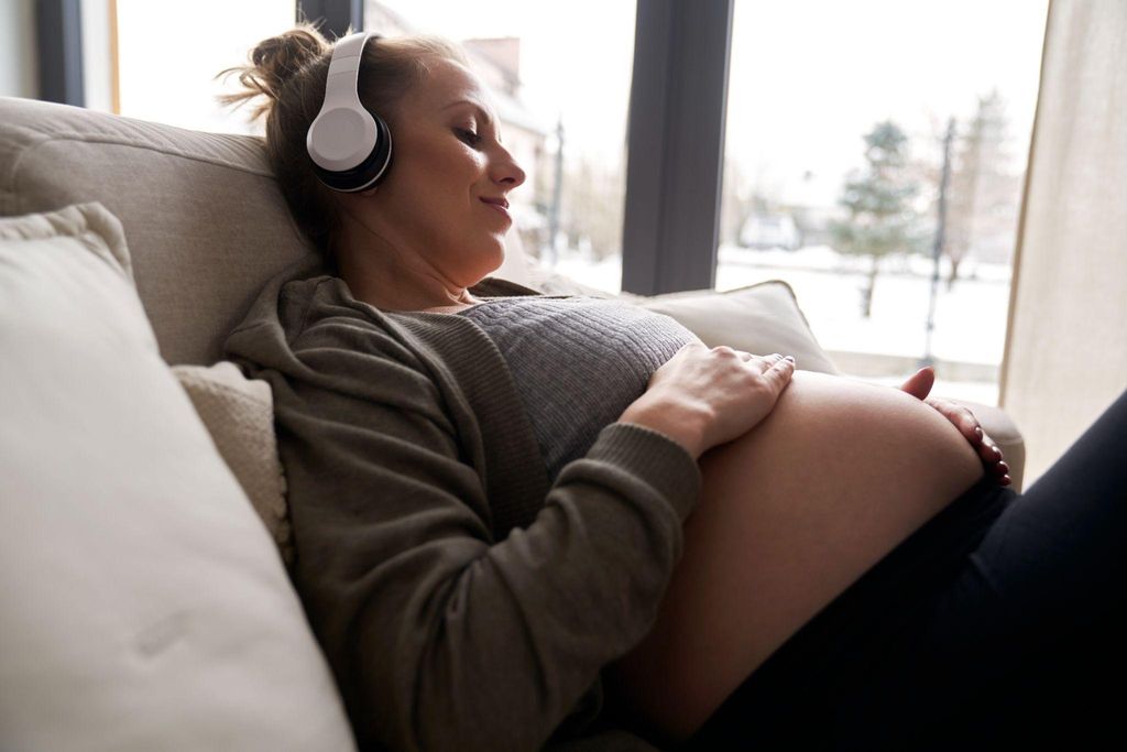 Expectant mother using breathing techniques learned from hypnobirthing courses alongside antenatal classes.