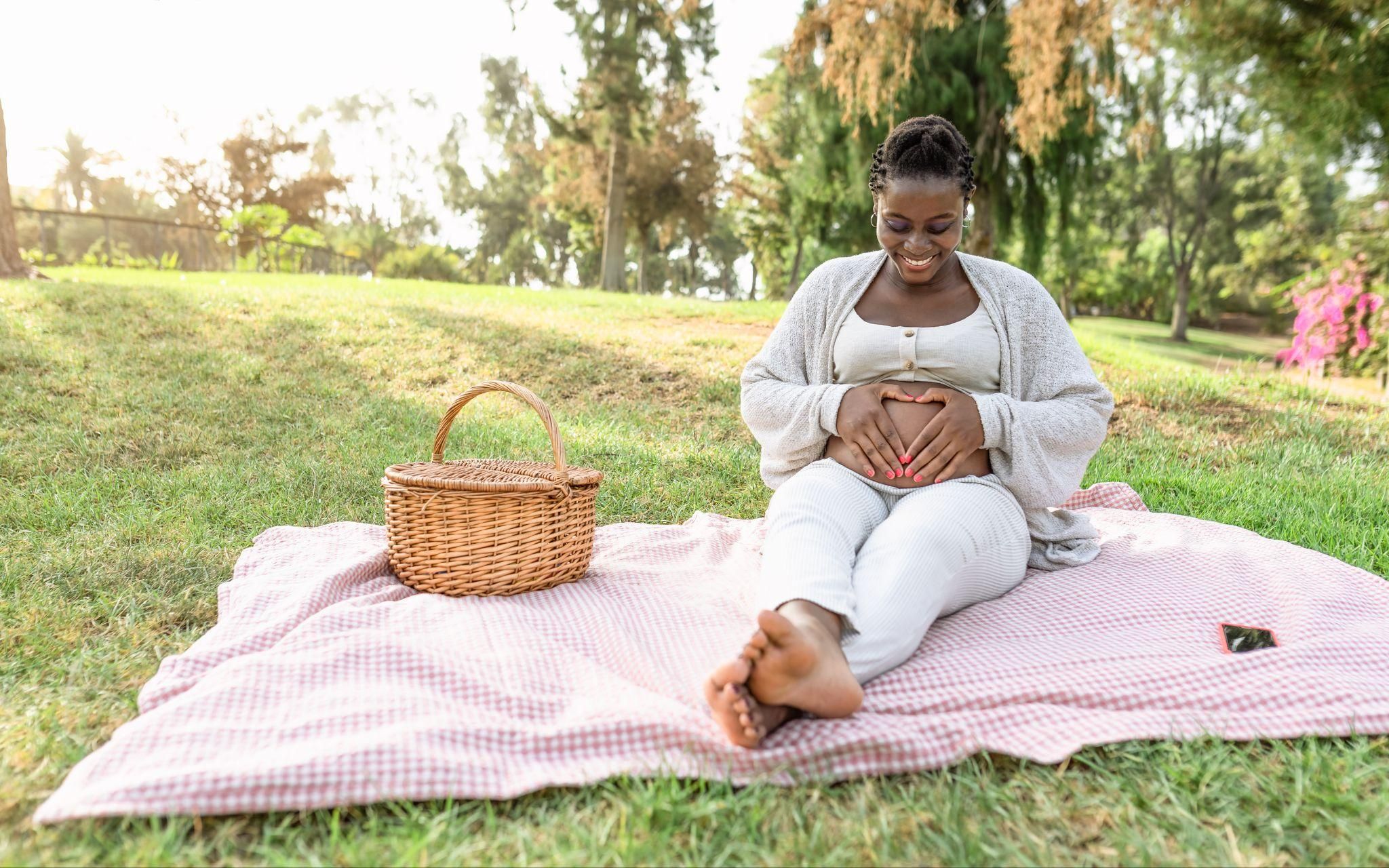 A pregnant woman sitting in Child’s Pose for comfort during the third trimester.