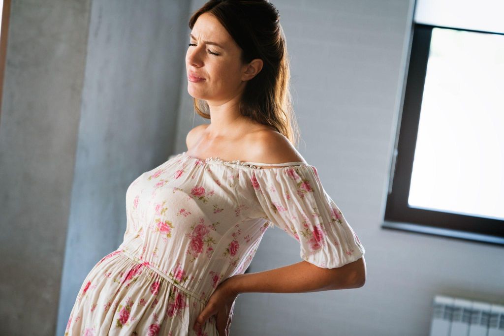 A new mother holding her baby, smiling and sober, reflecting the emotional and physical benefits of staying sober after childbirth.