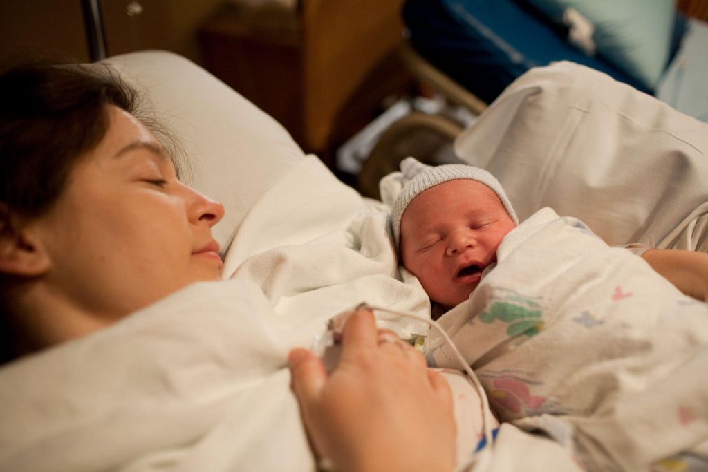 Parent bonding with their newborn right after birth.