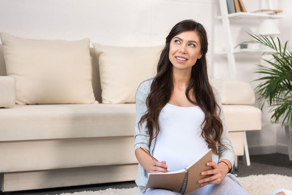 Pregnant woman discussing labour procedures with a midwife during an antenatal visit.