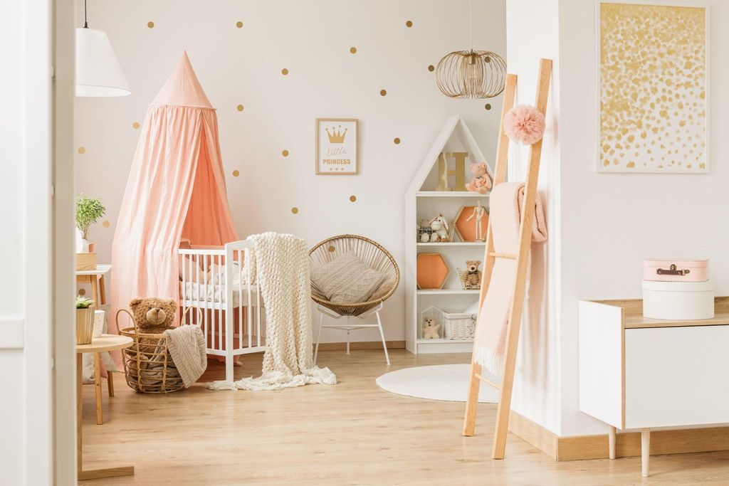 A charming and functional nursery for a baby girl with pastel colours, plush textures, and elegant decor.