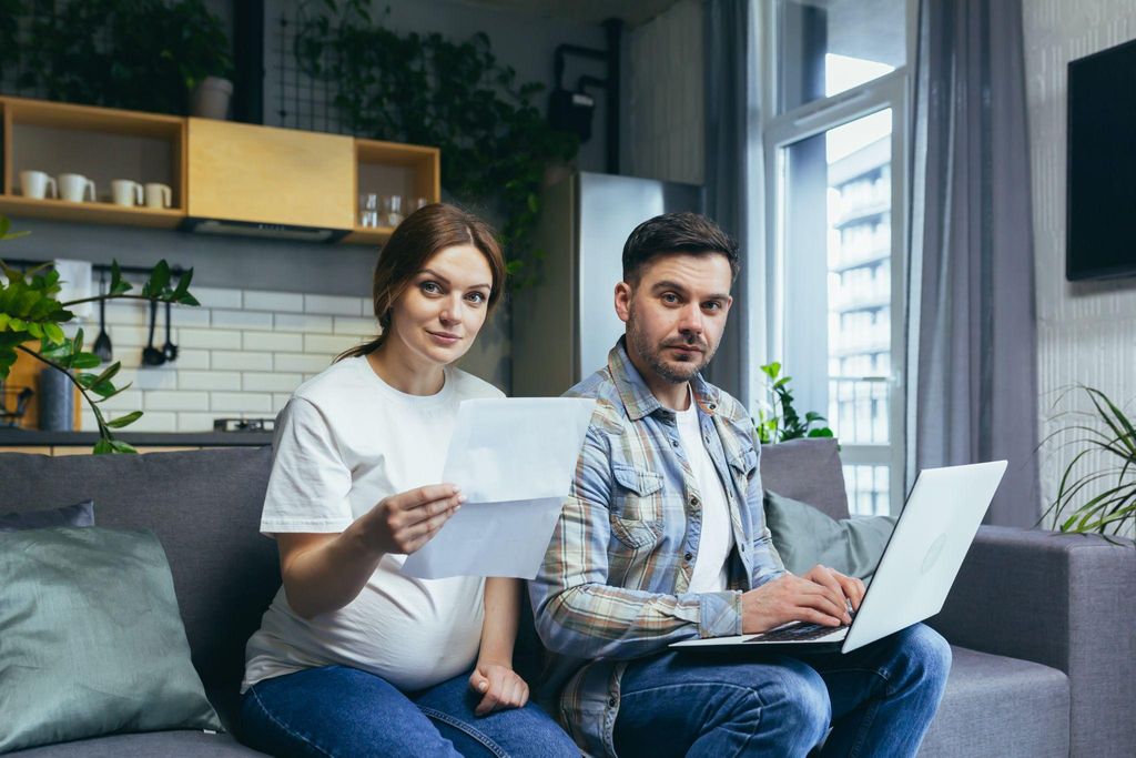 Parents planning their finances for a baby’s arrival.