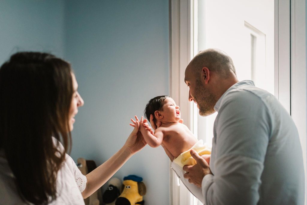 A midwife supporting a mother during a home birth in the UK.