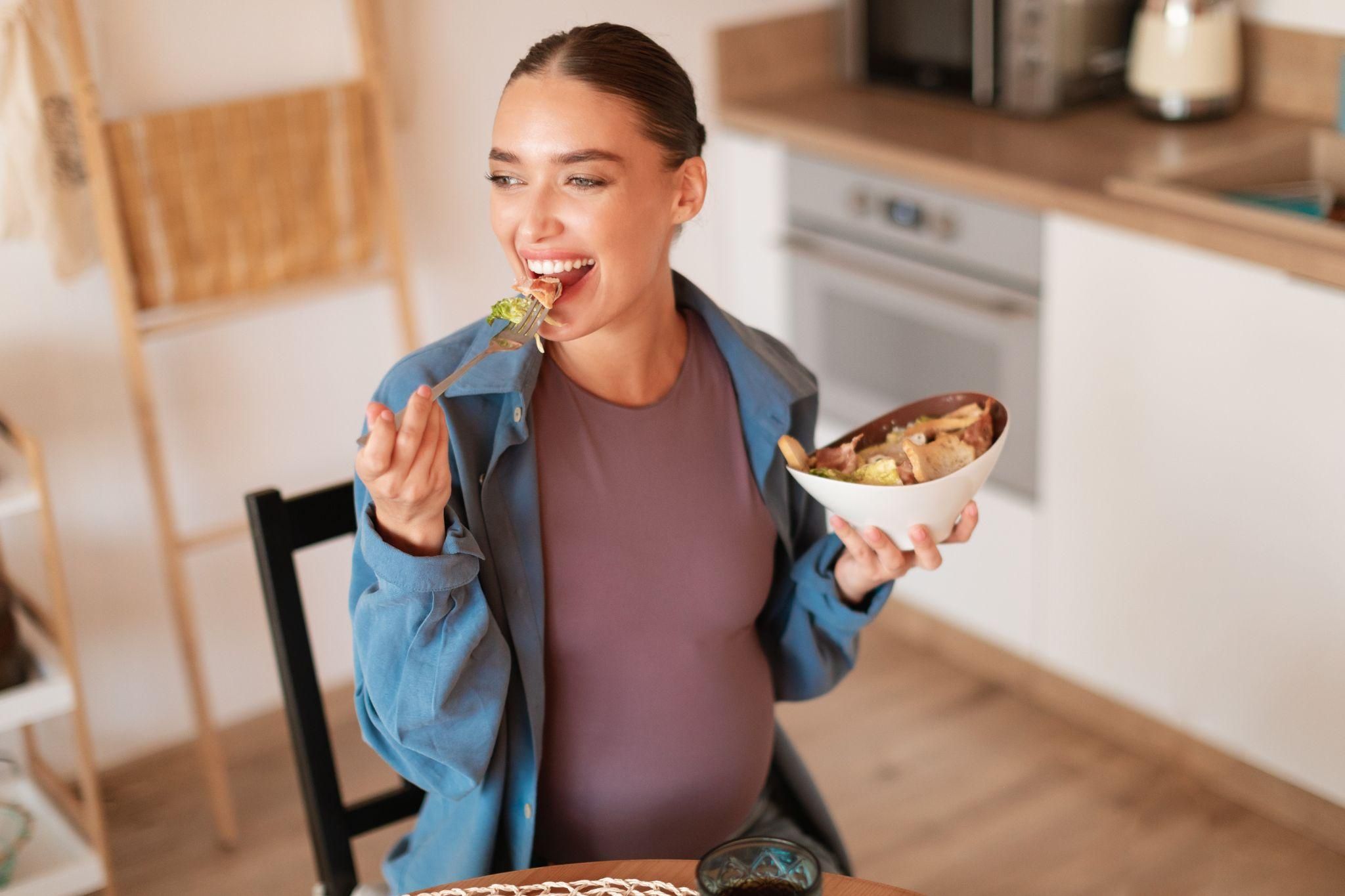 Pregnant woman enjoying a nutritious meal to support her baby’s development.