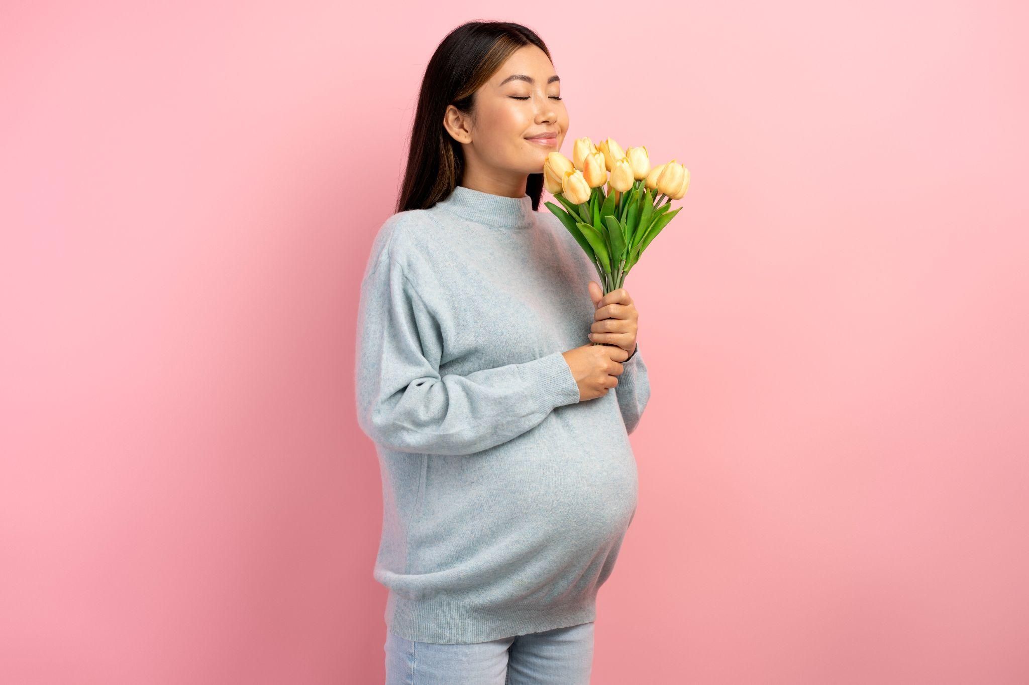 Pregnant woman connecting with her baby through the sense of smell while engaging in a calming activity