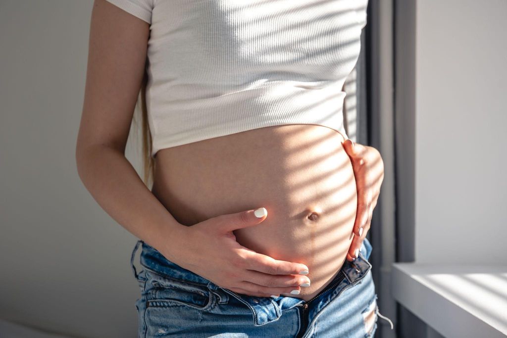 Pregnant woman experiencing Braxton Hicks contractions in a calm, comfortable environment.