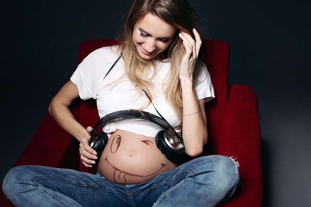 Expectant mother bonding with her unborn baby by talking to them in different languages.