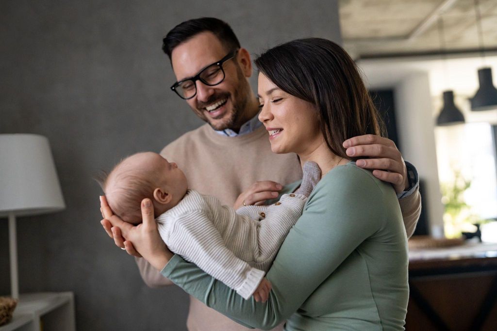 A new parent holding their newborn, experiencing the physical and emotional changes of the postpartum period.