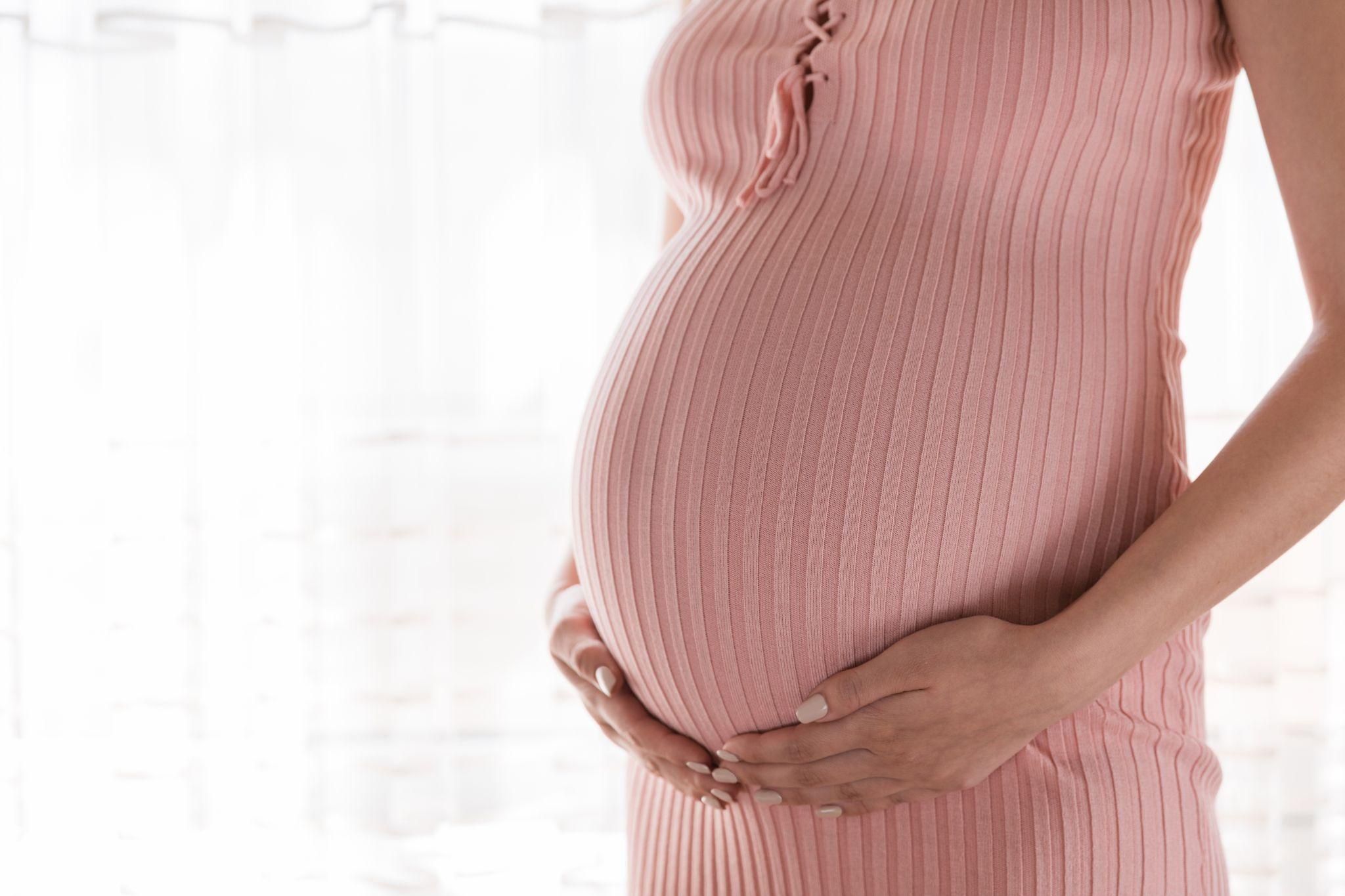 Pregnant woman at 35 weeks practising prenatal yoga.