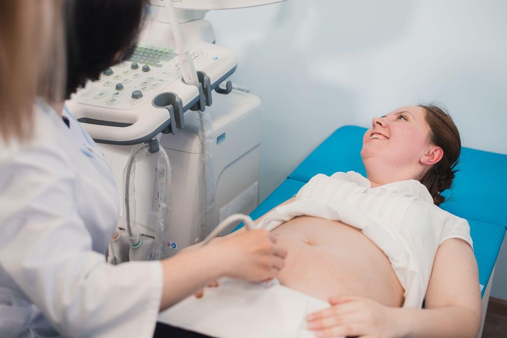 A sonographer conducting an antenatal scan in a UK antenatal clinic.