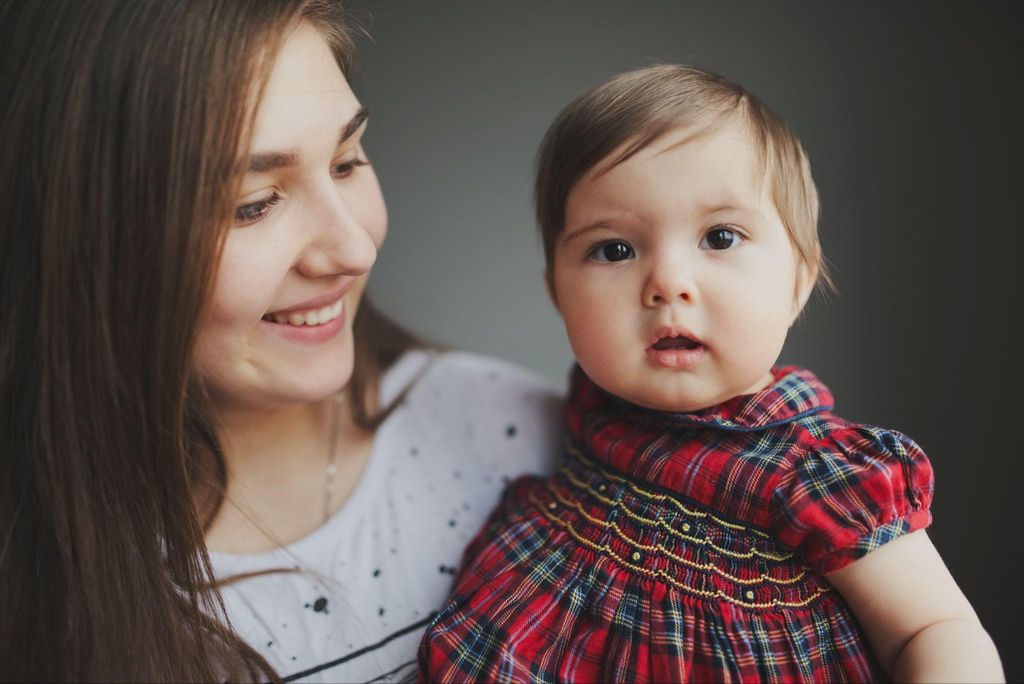 A mother cradling her baby while practising self-care and mindfulness.