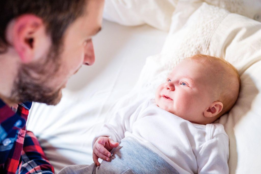 A father bonding with his newborn while supporting postpartum recovery.