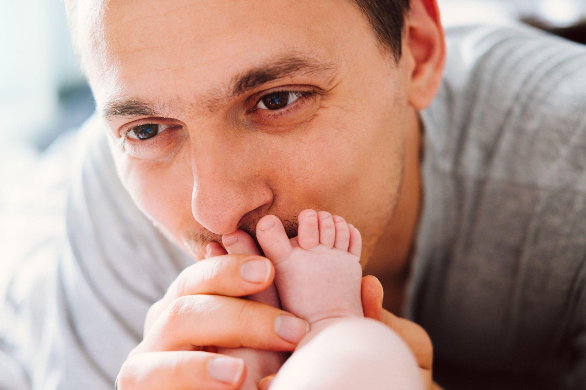 A first-time dad bonding with his baby and supporting his partner during the postpartum phase.