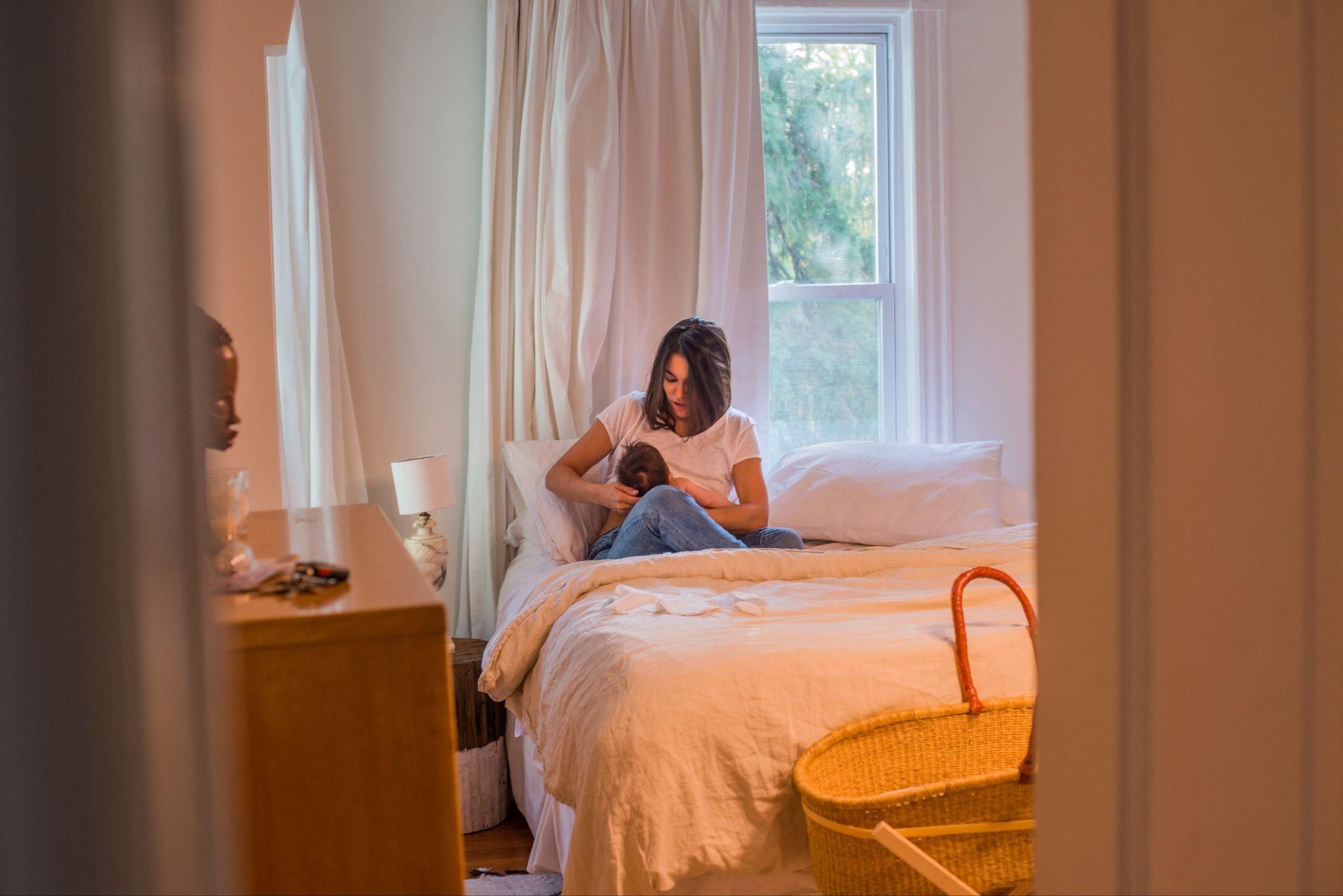 Midwife assisting with a home birth in a calm, supportive environment.