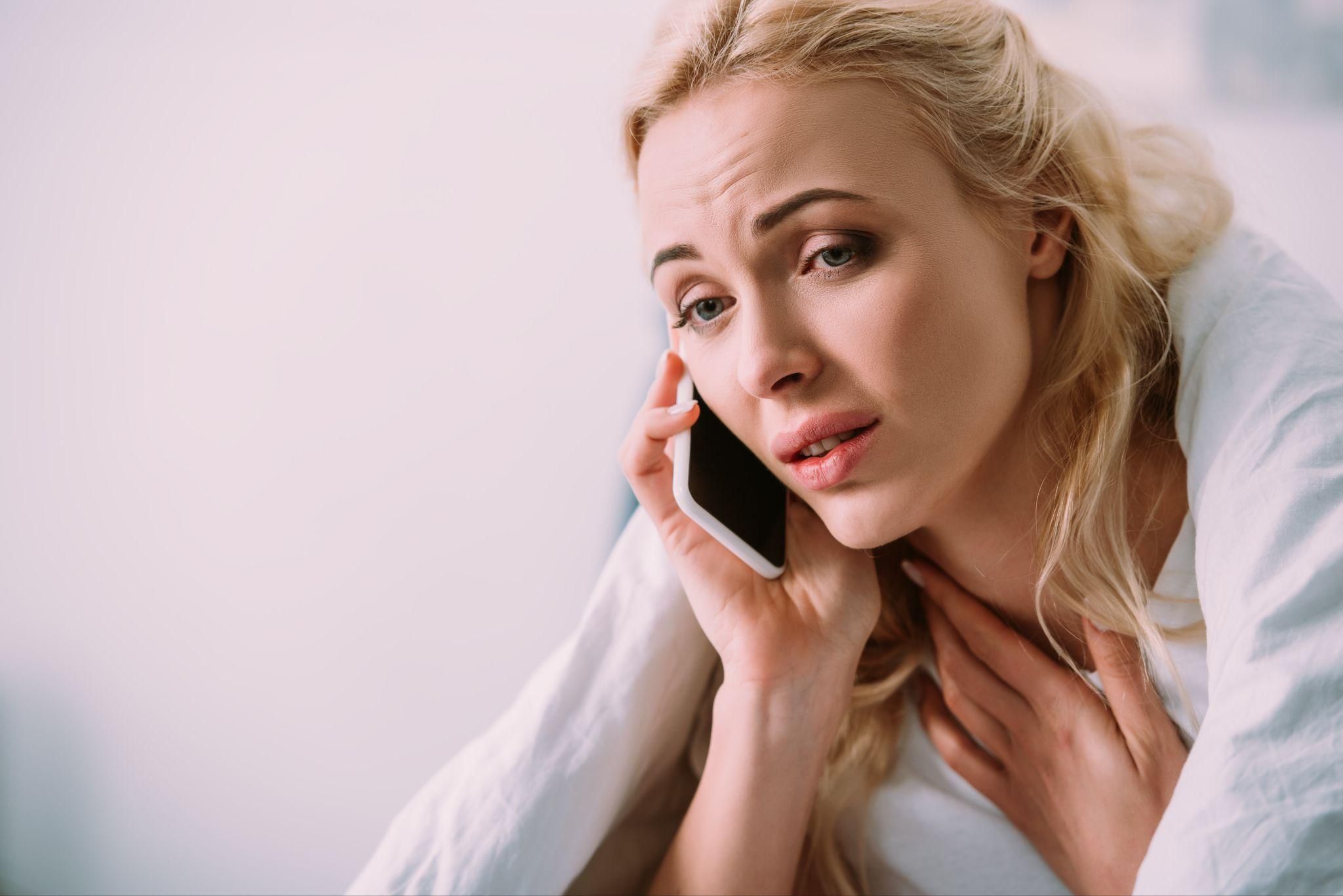 A pregnant woman talking with a healthcare provider on the phone.