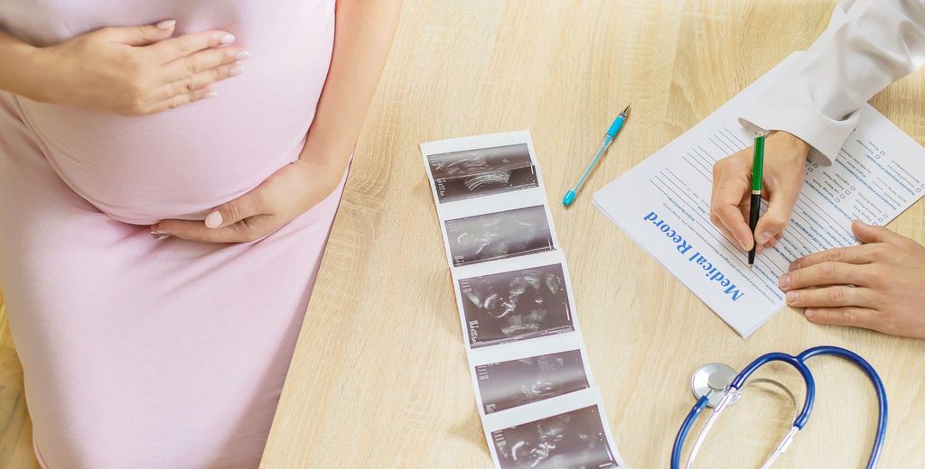 A healthcare provider conducting an antenatal scan to monitor a baby’s growth.