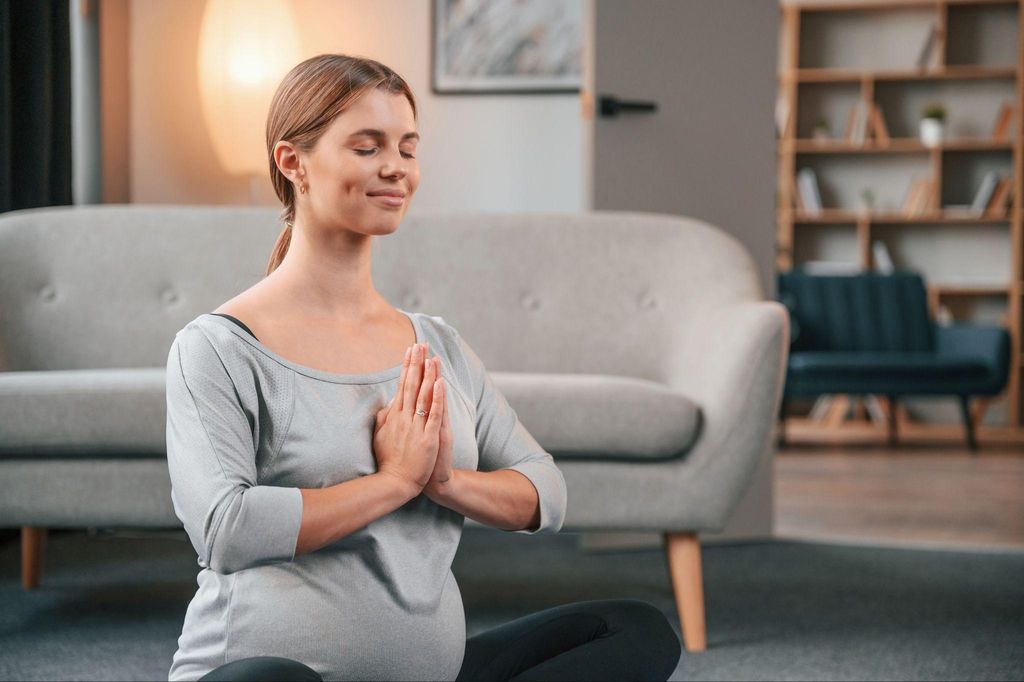 Pregnant woman practicing yoga during pregnancy for relaxation and fitness.