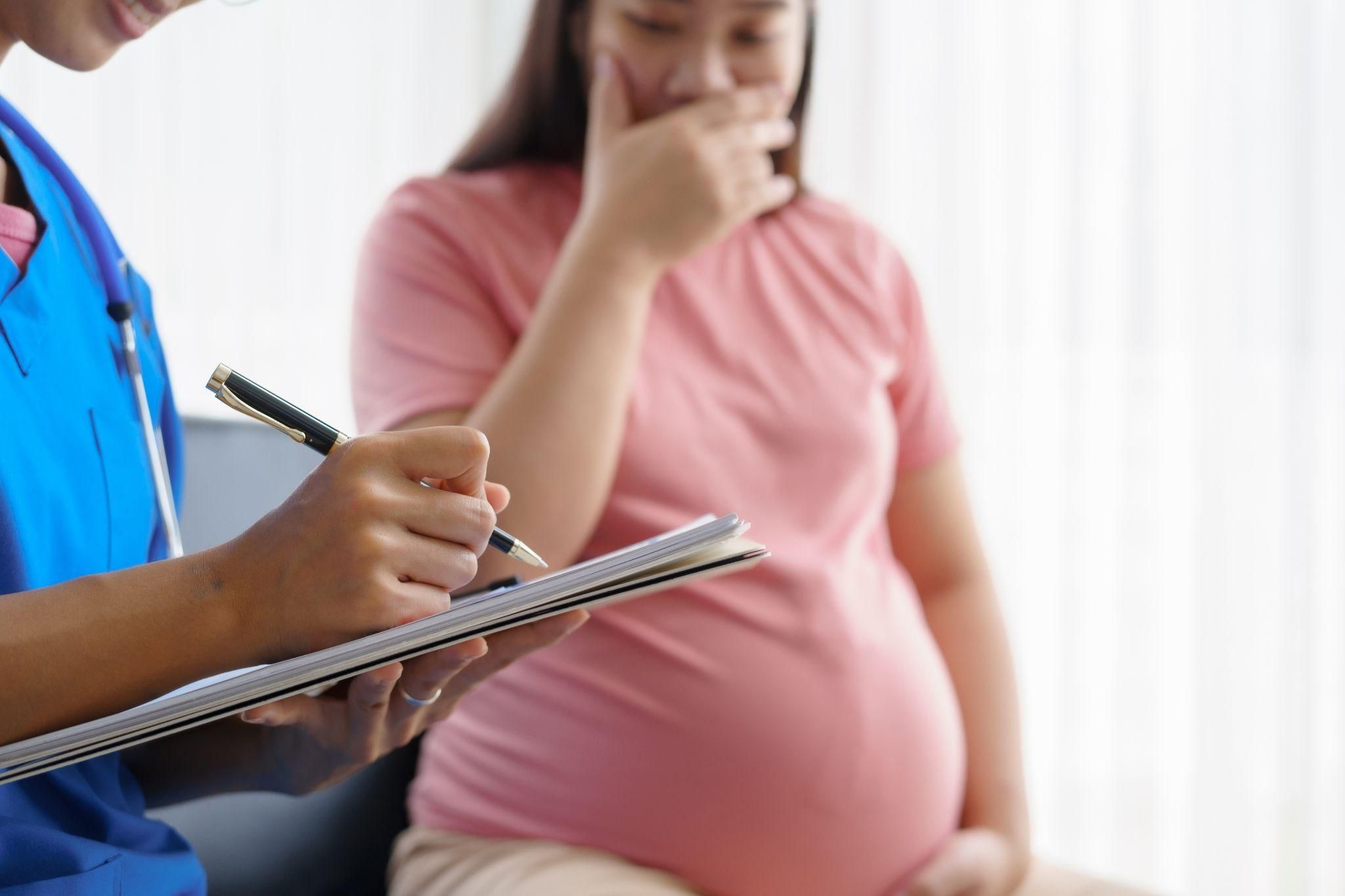 A pregnant woman discussing antenatal complications and their management with a doctor.