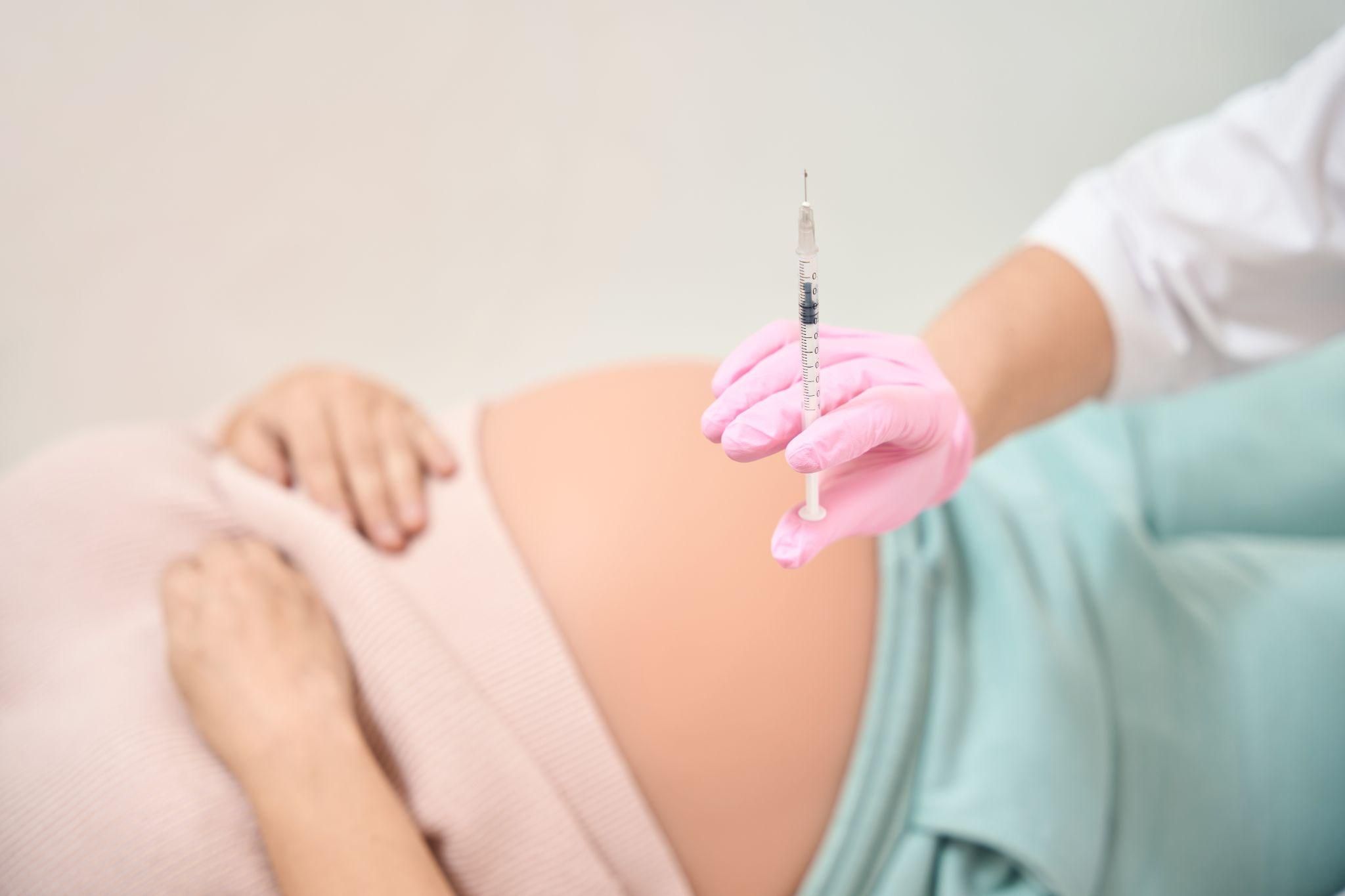 Pregnant woman awaits a Rhesus D injection during an antenatal consultation at her antenatal clinic. The medication prevents Rhesus disease.