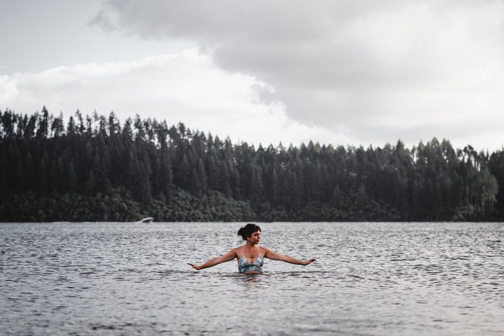 Pregnant woman enjoying safe swimming in a natural lake, reflecting the practice of wild swimming during pregnancy.