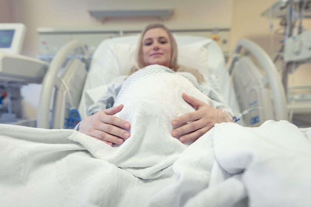 Midwife comforting a pregnant woman during labour.