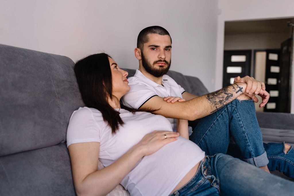 Couple sharing emotional intimacy during late pregnancy.