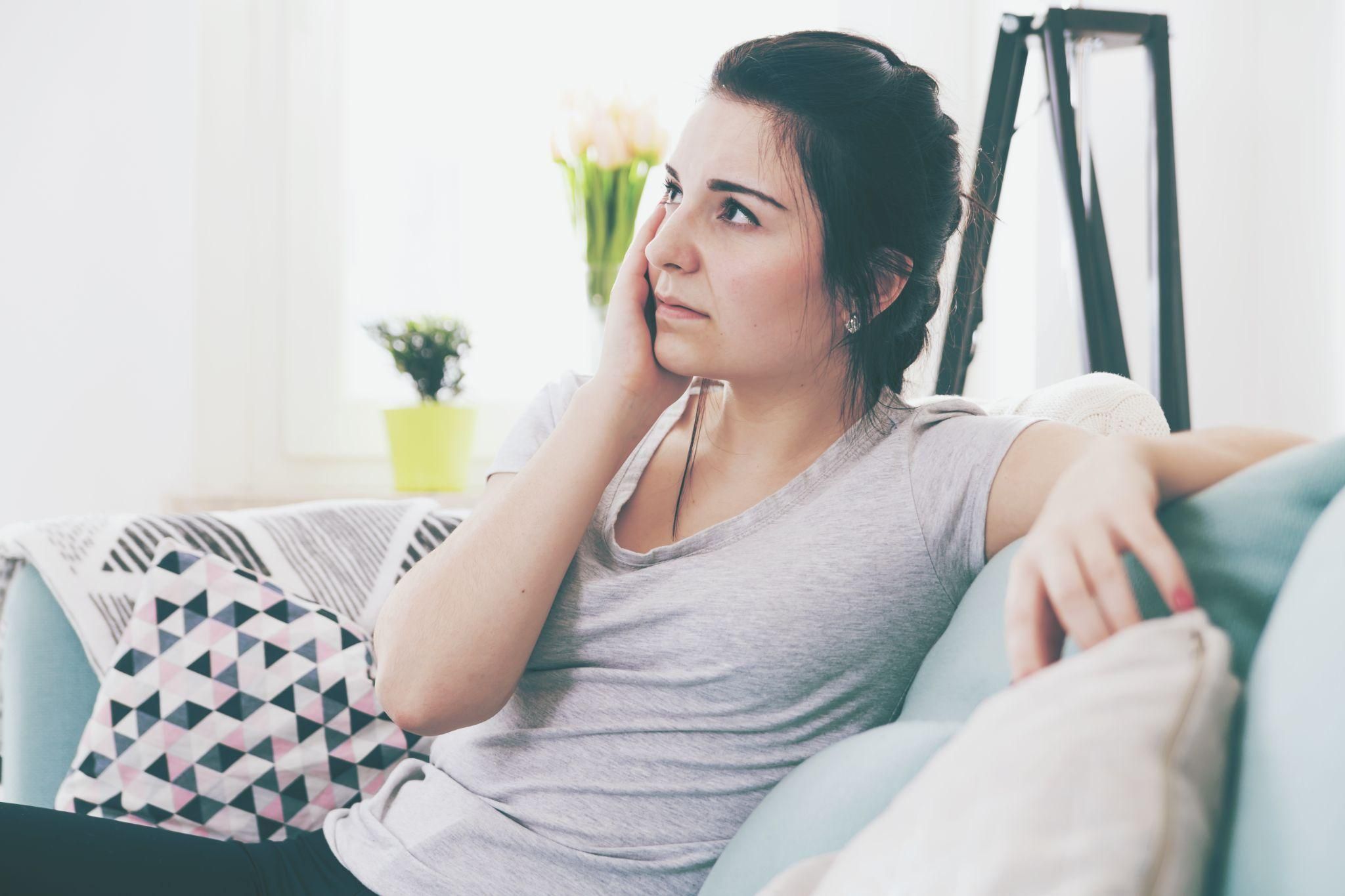 Pregnant woman experiencing antenatal care with her partner’s supportive gift of flowers.