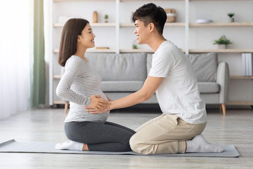 A couple attending antenatal education together, preparing for the birth of their child at 34 weeks pregnant.