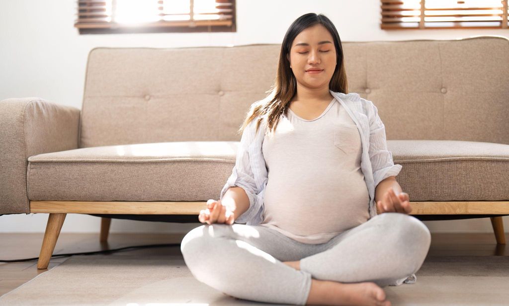 Pregnant woman practising relaxation and breathing techniques in preparation for labour.