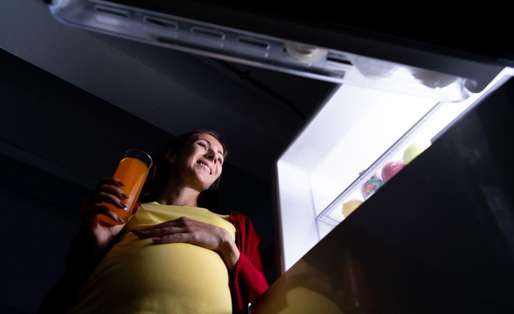 Pregnant woman considering meal replacement options for antenatal nutrition.