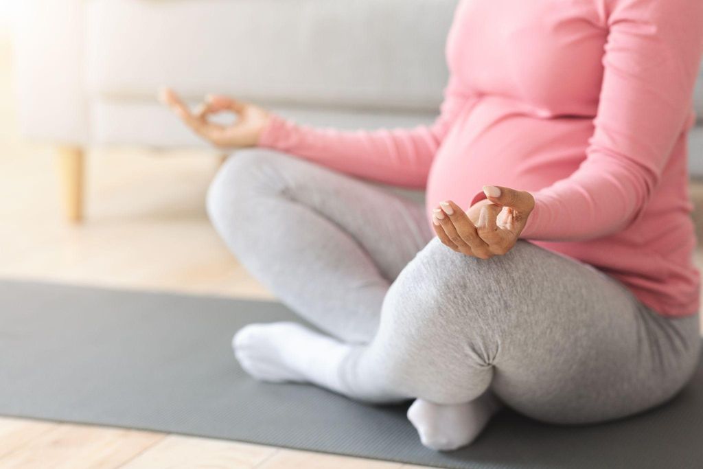 Pregnant woman holding her belly at 29 weeks gestation.