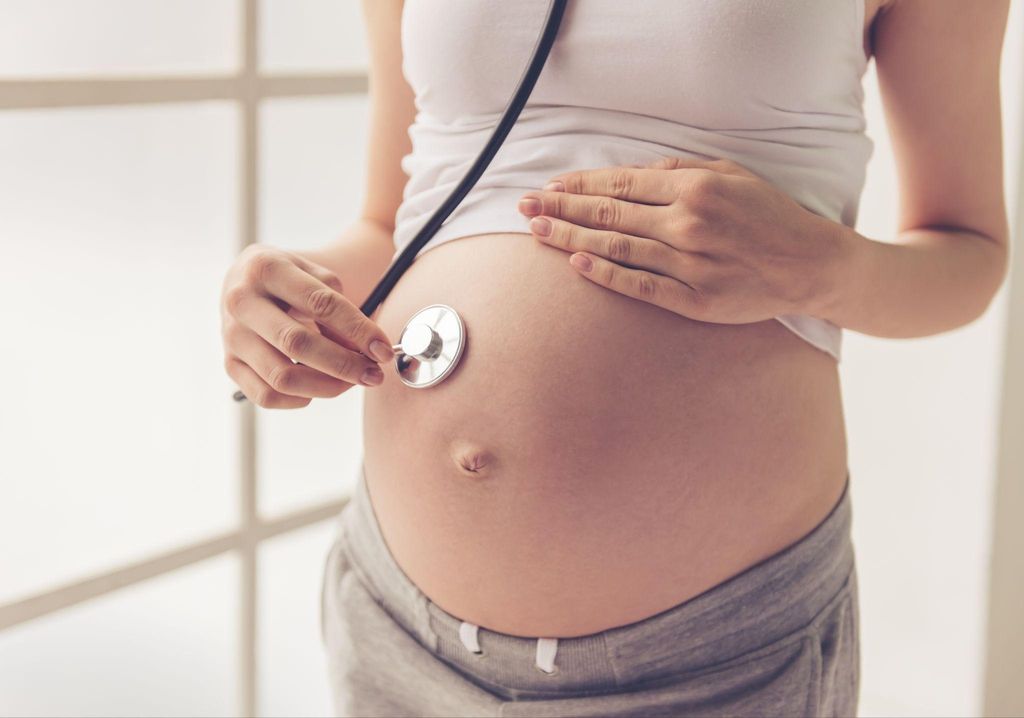 A healthcare provider discussing antenatal care with a pregnant woman.