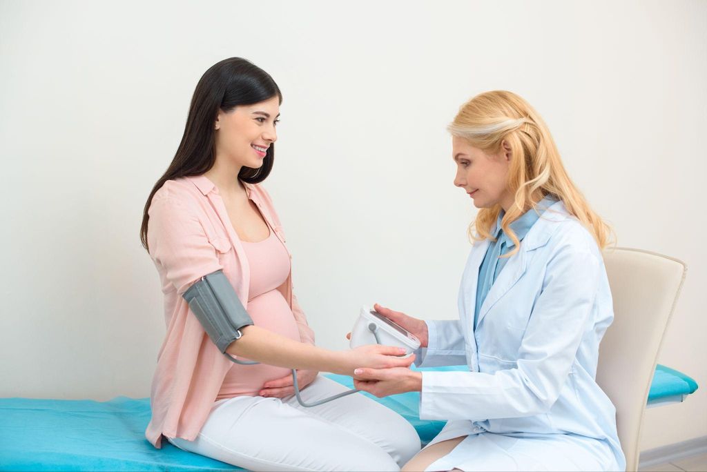 A healthcare provider discussing antenatal testing results with a pregnant woman.