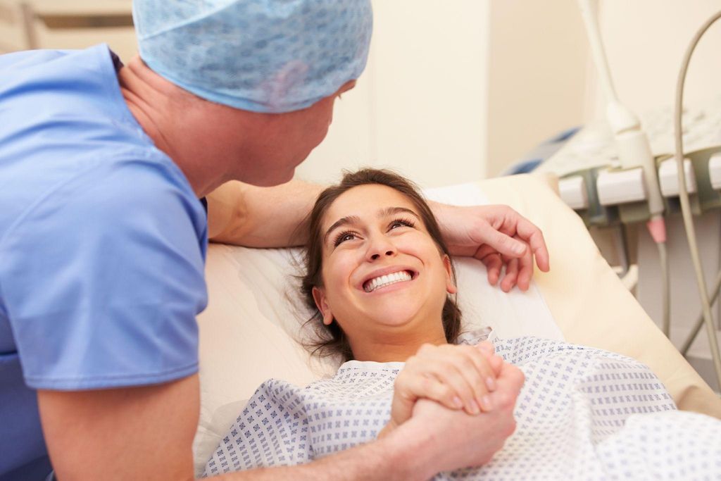 A mother and baby recovering together after a forceps delivery.