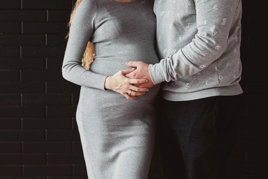 Pregnant woman and her husband practicing self-care and communication.