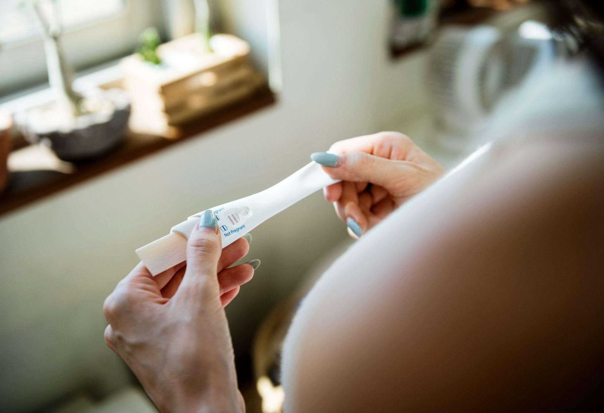 A happy mother-to-be celebrating early signs of pregnancy.