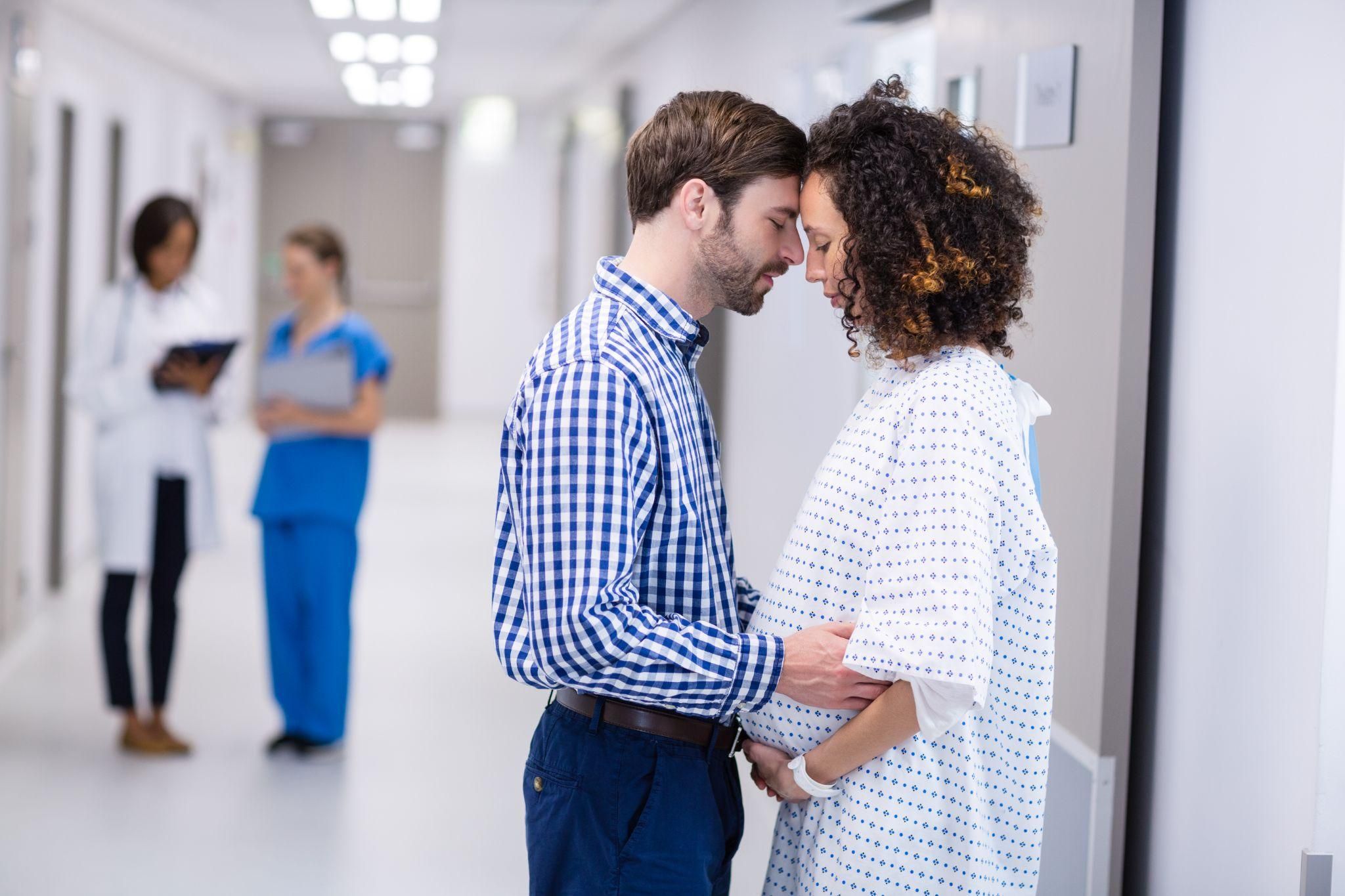 A couple learning about antenatal care at a clinic.