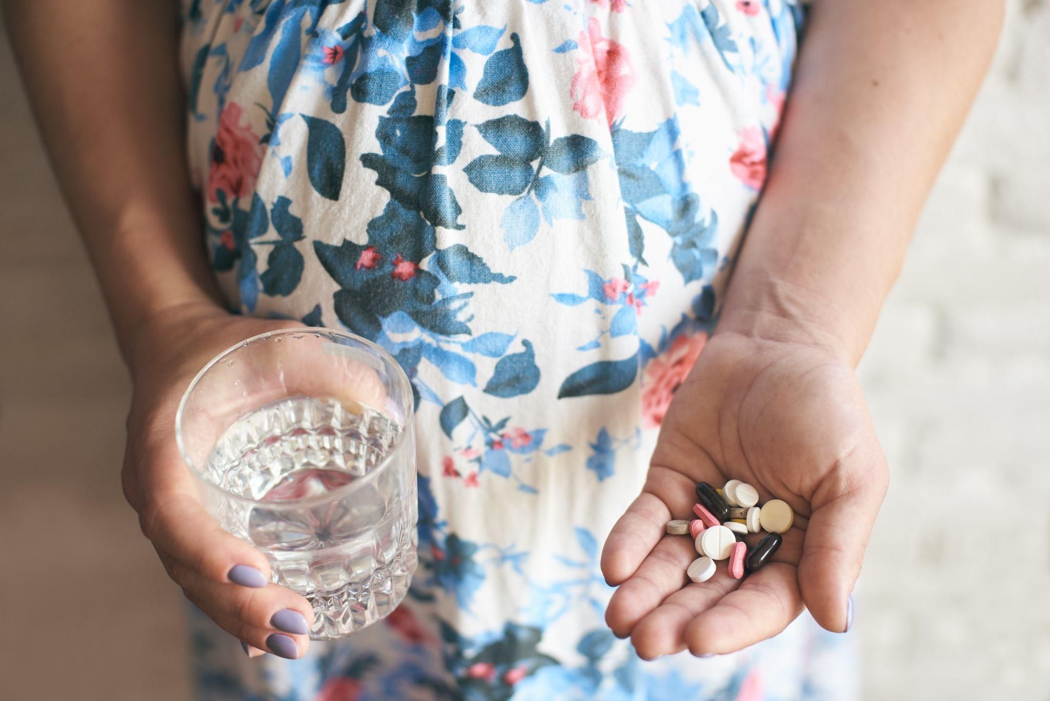 A pregnant woman discussing medication use during pregnancy with her healthcare provider.