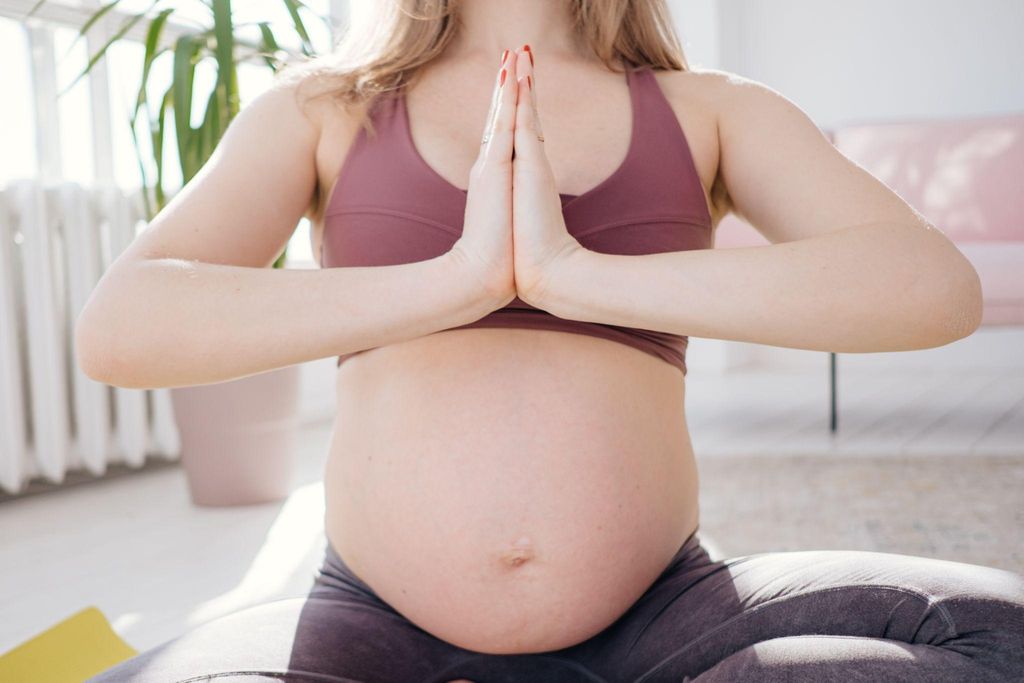 Pregnant woman practicing yoga for pregnancy to prepare for labour