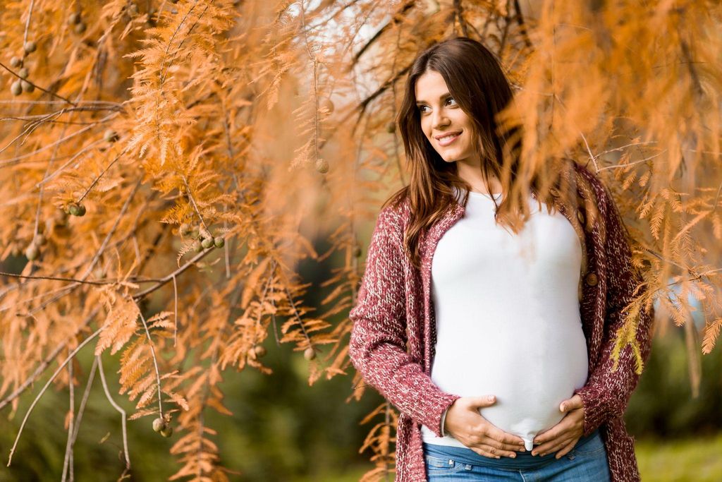 A pregnant woman learning relaxation techniques for antenatal birth preparation.