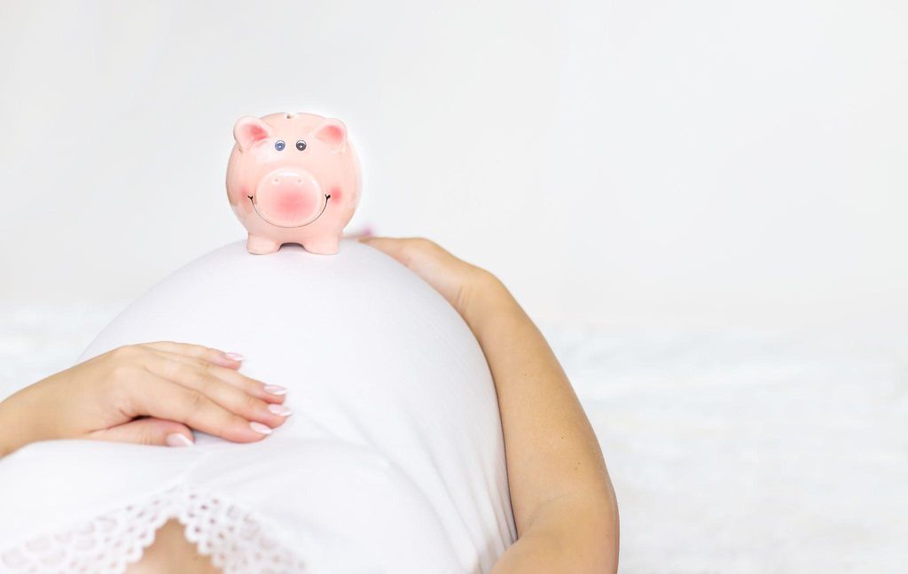 Parents discussing savings options with a piggy bank on the table.