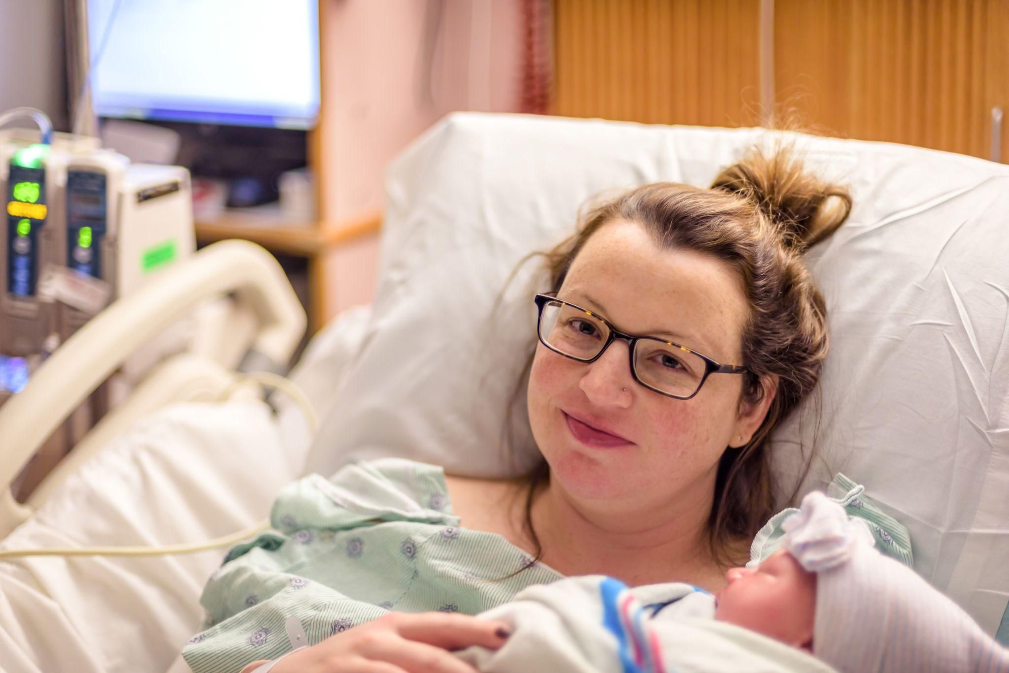 A midwife explaining Kiwi cup delivery to expectant parents during an antenatal appointment.